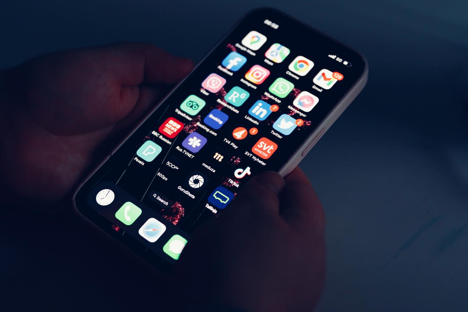 iPhone utilizado en un entorno oscuro con el Modo Oscuro activado, técnica clave para ahorrar batería en pantallas OLED.