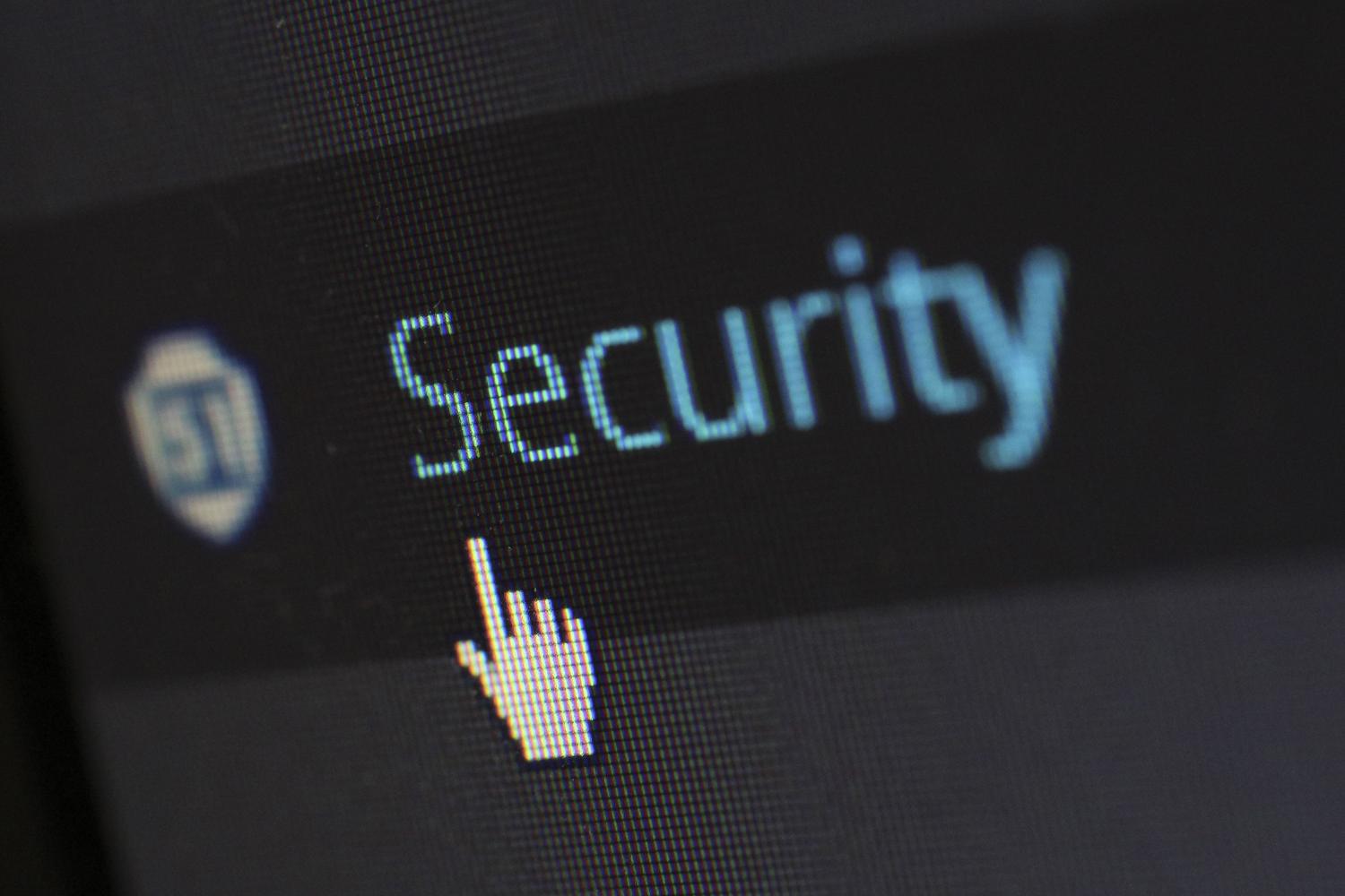 Close-up of a mouse cursor hovering over the word 'Security' on a digital screen, symbolizing the action of analyzing links and verifying digital safety.